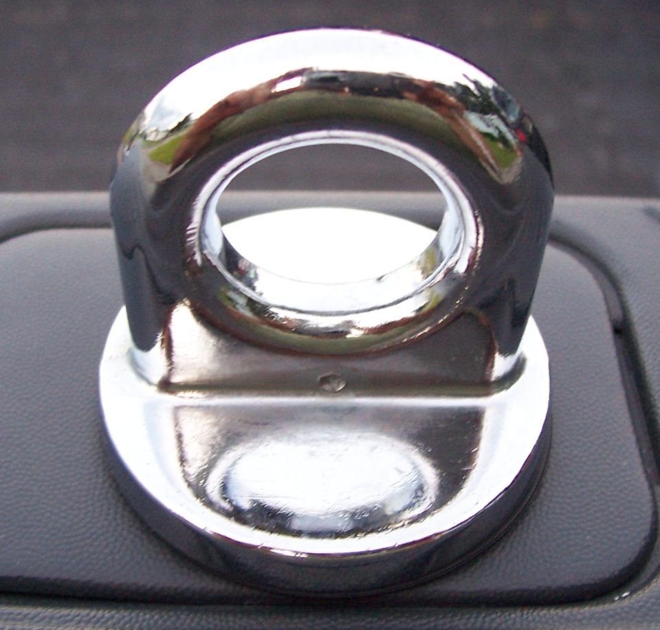 Chrome tow hook mounted on a black textured surface