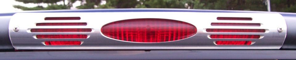 Chrome-trimmed third brake light with red lens and horizontal vents