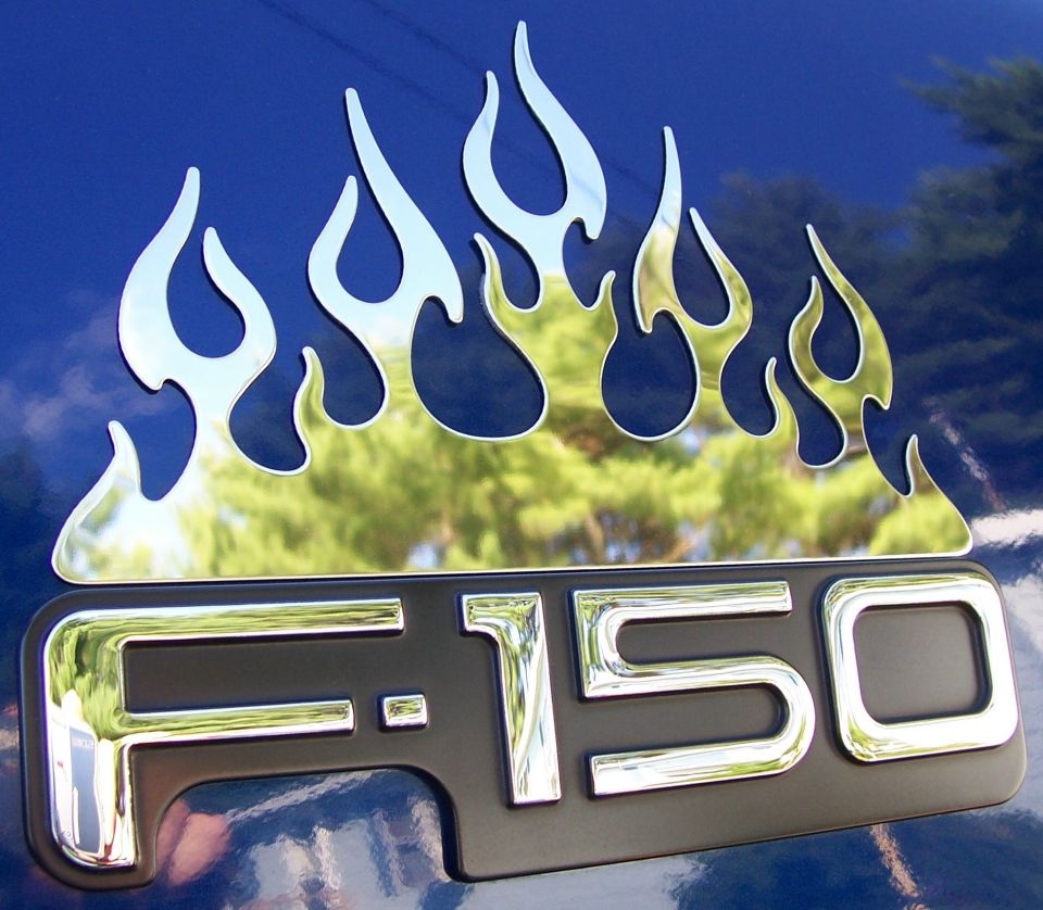 Chrome flame decals above F-150 badge on blue 1998 Ford F-150