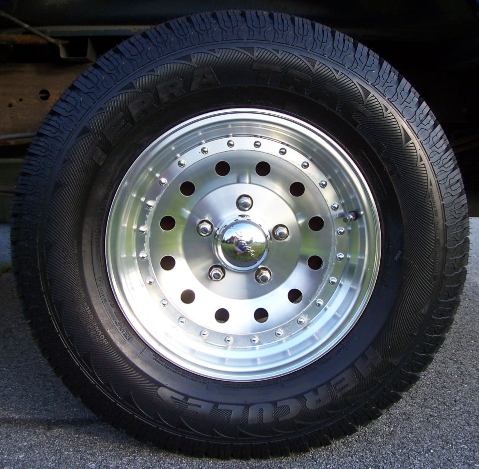 Hercules Terra Trac AT tire on polished silver 5-lug aluminum wheel with chrome center cap