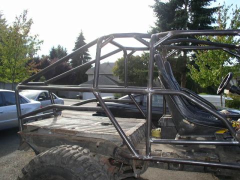 1979 Ford Bronco - This custom buggy features a full roll cage and bucket seats, with a modified bed and large off-road tires.