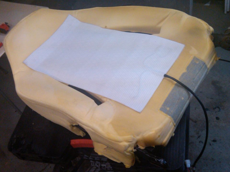 Car seat foam with heating element and wiring visible