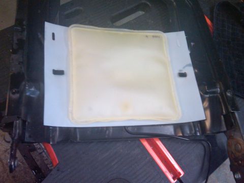 1993 Ford Bronco - Close-up of a seat heater element, possibly for a vehicle, resting on a white sheet.