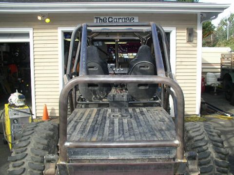 1979 Ford Bronco - Custom buggy interior and bed with roll cage, two seats, and metal bed. Welding equipment is nearby.