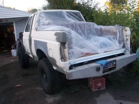 1989 Ford Bronco - This 1989 Ford Bronco is seen from the rear, covered in plastic sheeting as it undergoes body work.