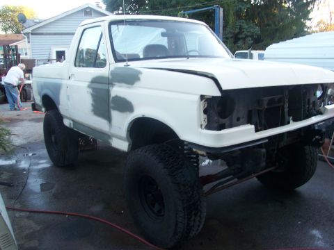 1989 Ford Bronco - This 1989 Ford Bronco is undergoing body work, with primer visible on the fenders and doors.