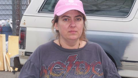 1989 Ford Bronco - This 1989 Ford Bronco is seen from the rear, with a woman in a pink hat and AC/DC shirt in the foreground.