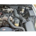 1998 Ford Crown Victoria - Very small, low-resolution engine-bay photo of a car, showing an engine with black plastic intake ducting, belt-driven accessories and hose…