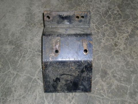 1979 Ford Bronco - This is a metal bracket with visible rust and bolt holes, resting on a concrete surface.