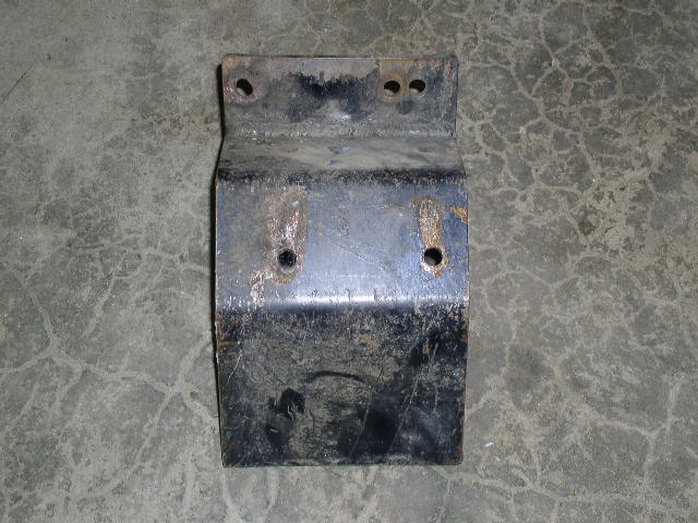 black metal bracket with rust spots and bolt holes, on concrete floor