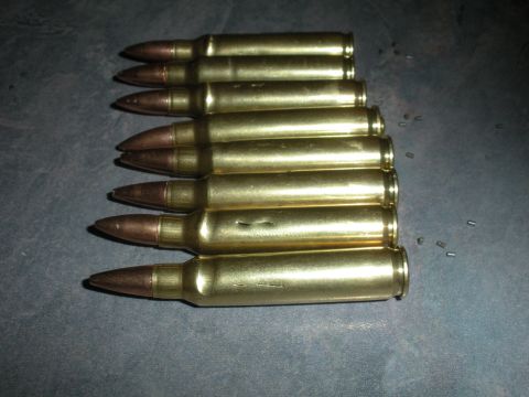 1996 Ford Bronco - A group of rifle cartridges are visible on a textured surface.