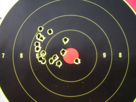 1996 Ford Bronco - A target shows numerous bullet holes, with most concentrated near the bullseye and a cluster to the left.