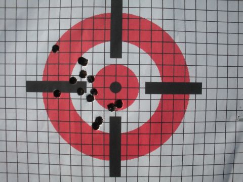 1996 Ford Bronco - A target shows a grouping of bullet holes, indicating accuracy at a shooting range.
