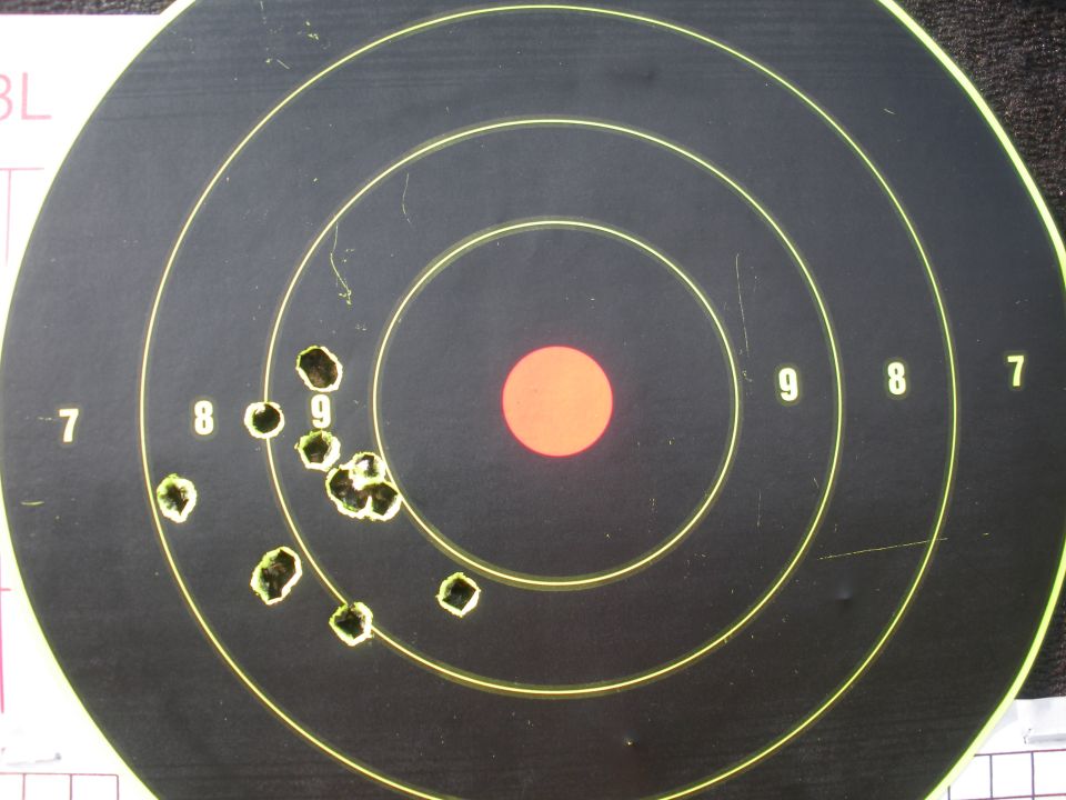 Target with bullet holes and score numbers 7, 8, and 9