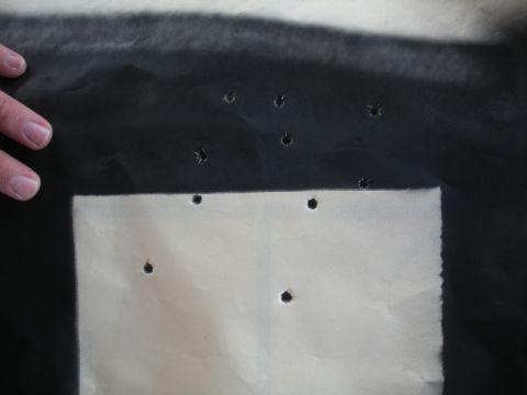 1996 Ford Bronco - Paper target shows numerous bullet impacts, indicating shooting practice.