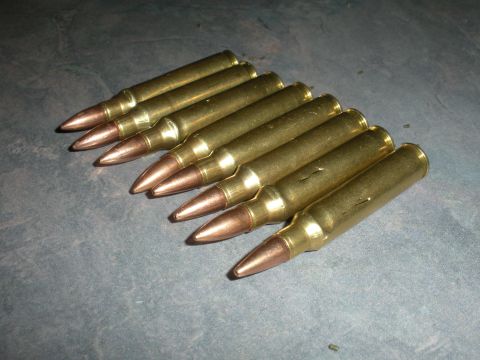 1996 Ford Bronco - A group of rifle cartridges are laid out on a textured surface, with the Supermotors.net watermark visible in the lower right corner.