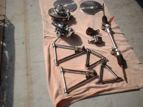1971 Ford Ranchero - Various chrome-plated automotive suspension components and a steering rack are displayed on a cloth, with a "Supermotors.net" watermark vis…