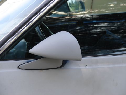 1973 Ford Ranchero - Close-up of a white car's side mirror and door panel, with reflections visible in the window.