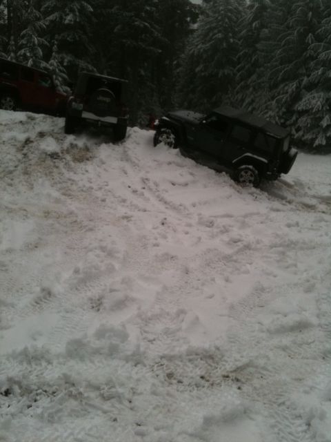 2005 Jeep Wrangler - Two Jeep Wranglers navigate a snow-covered mountain road.