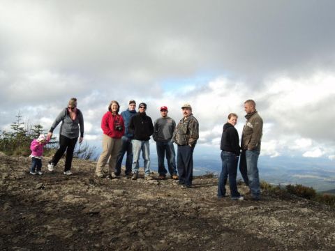 2005 Jeep Wrangler - A group of people, including a child, pose for a photo on a scenic overlook with a cloudy sky.