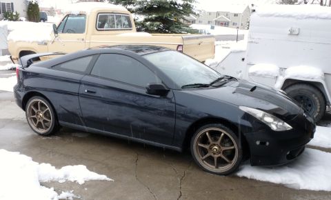 2006 Ford E350 - Dark coupe with aftermarket wheels parked in snowy conditions.