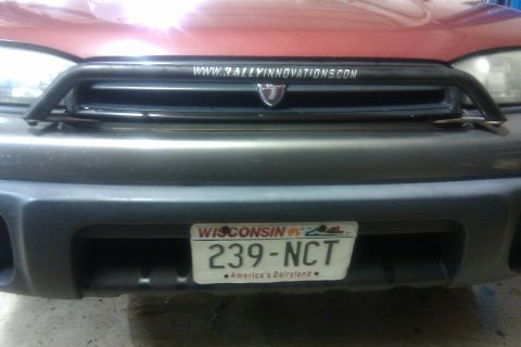 1998 Subaru Legacy - Front view of a red vehicle with a bull bar and a Wisconsin license plate.