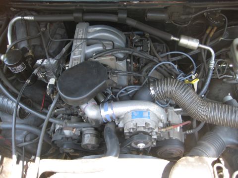 1992 Ford Bronco - Close-up view of a vehicle's engine compartment, showing various components and wiring.
