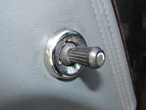 1973 Ford Ranchero - Door lock knob with a curved arrow symbol, likely from an older vehicle's interior.