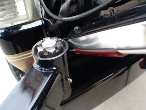 1996 Ford Bronco - Detail shot of a vehicle's front structure, including a headlight and a unique bolt on the frame.