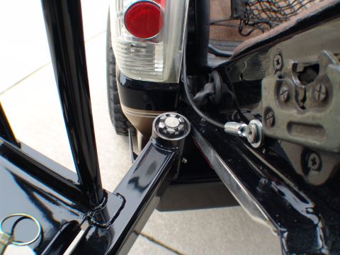 1996 Ford Bronco - Close-up of a black metal frame attached to the rear of an SUV, focusing on the tailgate mechanism and taillight assembly.