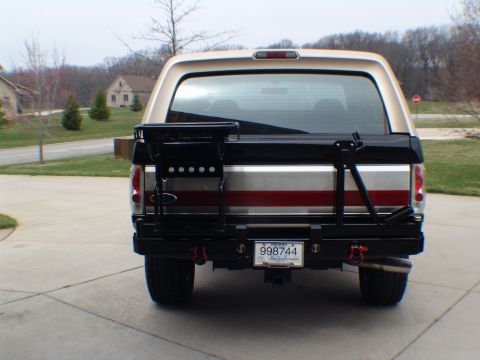 1996 Ford Bronco - The rear of a 1996 Ford Bronco features a custom bumper and a spare tire carrier mounted on the tailgate.