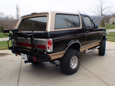 1996 Ford Bronco - This Ford Bronco features a two-tone paint scheme and a custom rear bumper with a tire carrier.