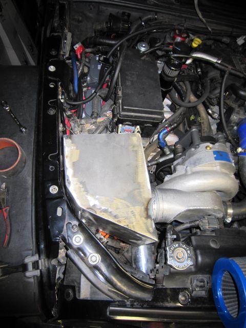2008 Jeep Wrangler - Custom metal fabrication for an engine intake system is underway in the engine bay.