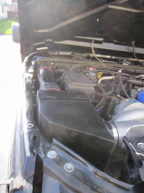 2008 Jeep Wrangler - Aftermarket cold air intake system installed in the engine bay of a Jeep Wrangler.