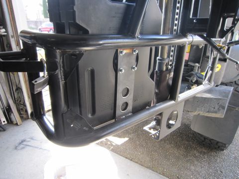 2008 Jeep Wrangler - Close-up of a fabricated tubular rear rack under construction, with welded tube bends and a bolt-on flat mounting plate holding a black pla…