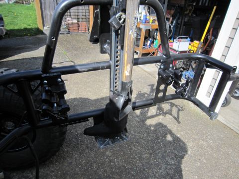 2008 Jeep Wrangler - A hi-lift jack is mounted to the rear of a vehicle, secured with a padlock.