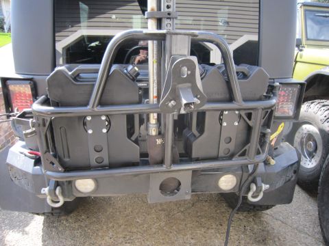 2008 Jeep Wrangler - Rear view of a black Jeep Wrangler wearing an aftermarket steel rear bumper with D-ring shackles, recessed round backup lights and a tubula…