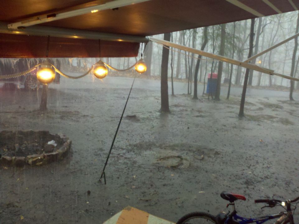 Rainy scene with awning and lights, bicycle in foreground