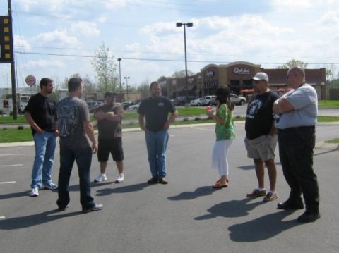 2007 Ford Mustang - Several people gather in a parking lot near fast-food restaurants under a partly cloudy sky.