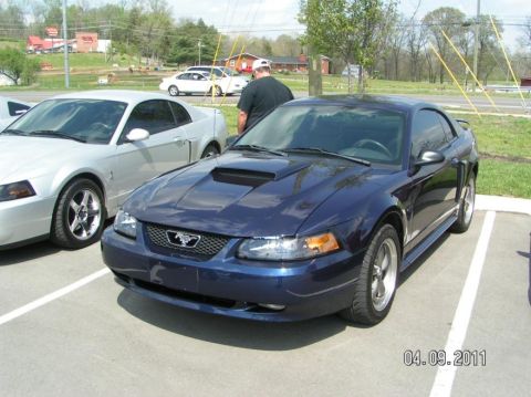 2007 Ford Mustang - A dark blue Ford Mustang coupe is parked in a lot next to a silver Mustang. The photo was taken on April 9, 2011.