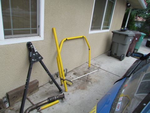 1995 Ford Probe - An exhaust pipe and yellow roll cage frame are visible on a concrete patio.