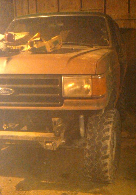 1988 Ford Bronco - Front view of a 1987 Ford Bronco, modified with large tires and a custom bumper.