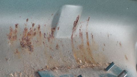 1992 Ford Bronco - Close-up view of rust forming on a vehicle's metal surface.