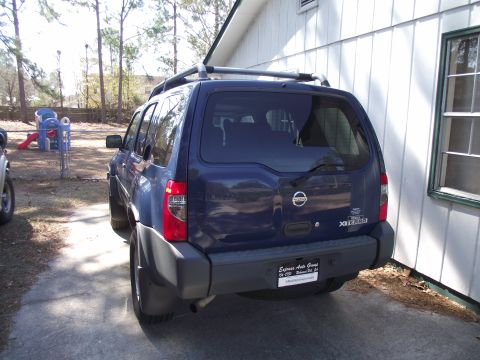 2004 Nissan Xterra - Rear view of a blue 2004 Nissan Xterra SUV parked on a driveway.