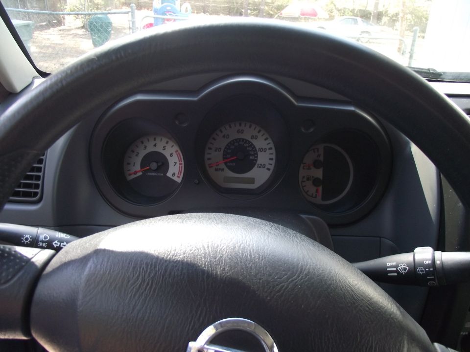 2004 Nissan Xterra interior dashboard with speedometer, tachometer, and fuel gauge visible