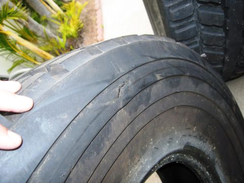 1986 Ford Bronco - A close-up view of a damaged tire, showing significant wear and tear.