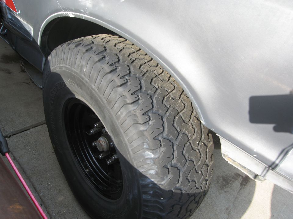 Silver SUV fender and tire with BFG All Terrains 315/75/16