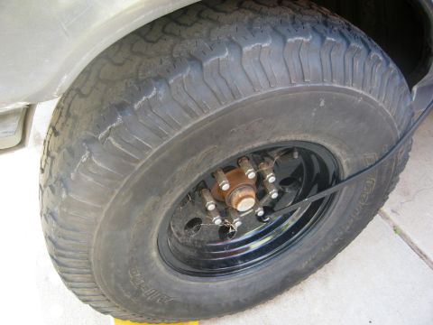 1986 Ford Bronco - Close-up of a BFGoodrich All-Terrain tire mounted on a black wheel.
