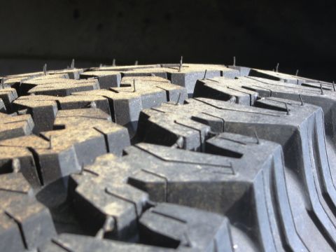 1986 Ford Bronco - Tire tread detail, showing the aggressive block pattern and manufacturing remnants.