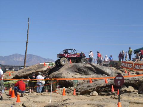 1979 Ford Bronco - A custom-built buggy is shown attempting to climb a steep, rocky incline during an off-road competition.